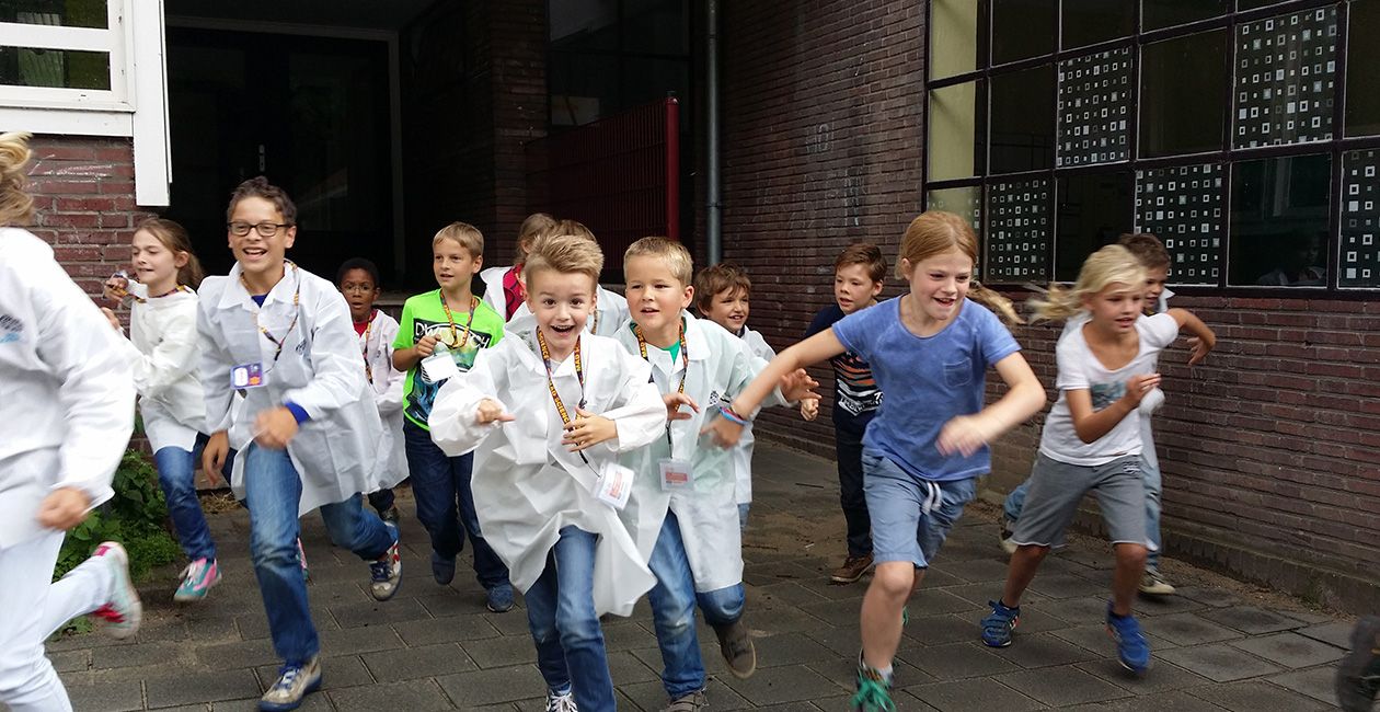 Kids in mad science lab coats running out of school