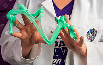 Mad Scientist stretching green putty.